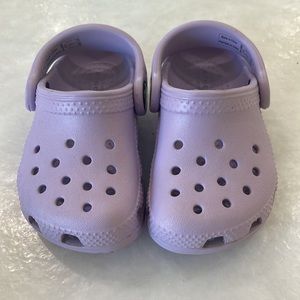 Purple little crocs for you little one.